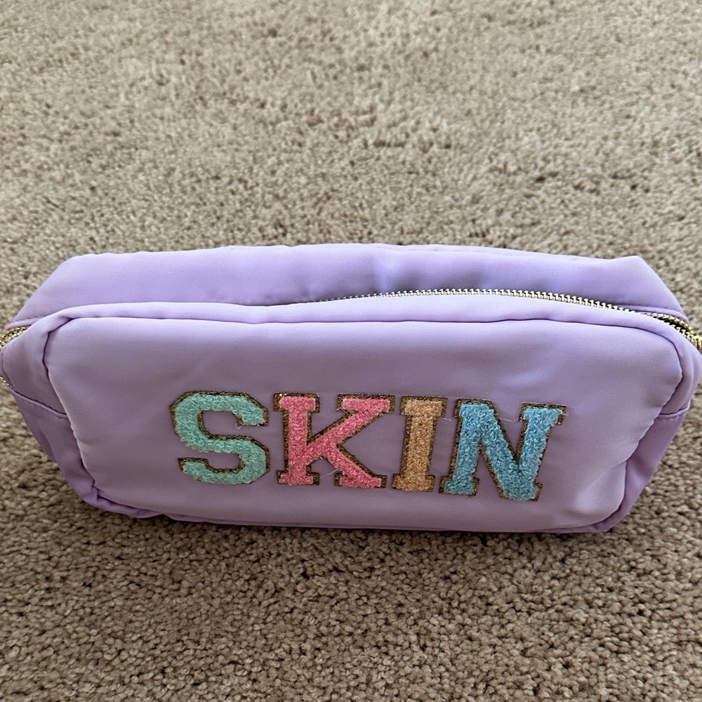 Purple Cosmetic Bag with Colorful SKIN Logo